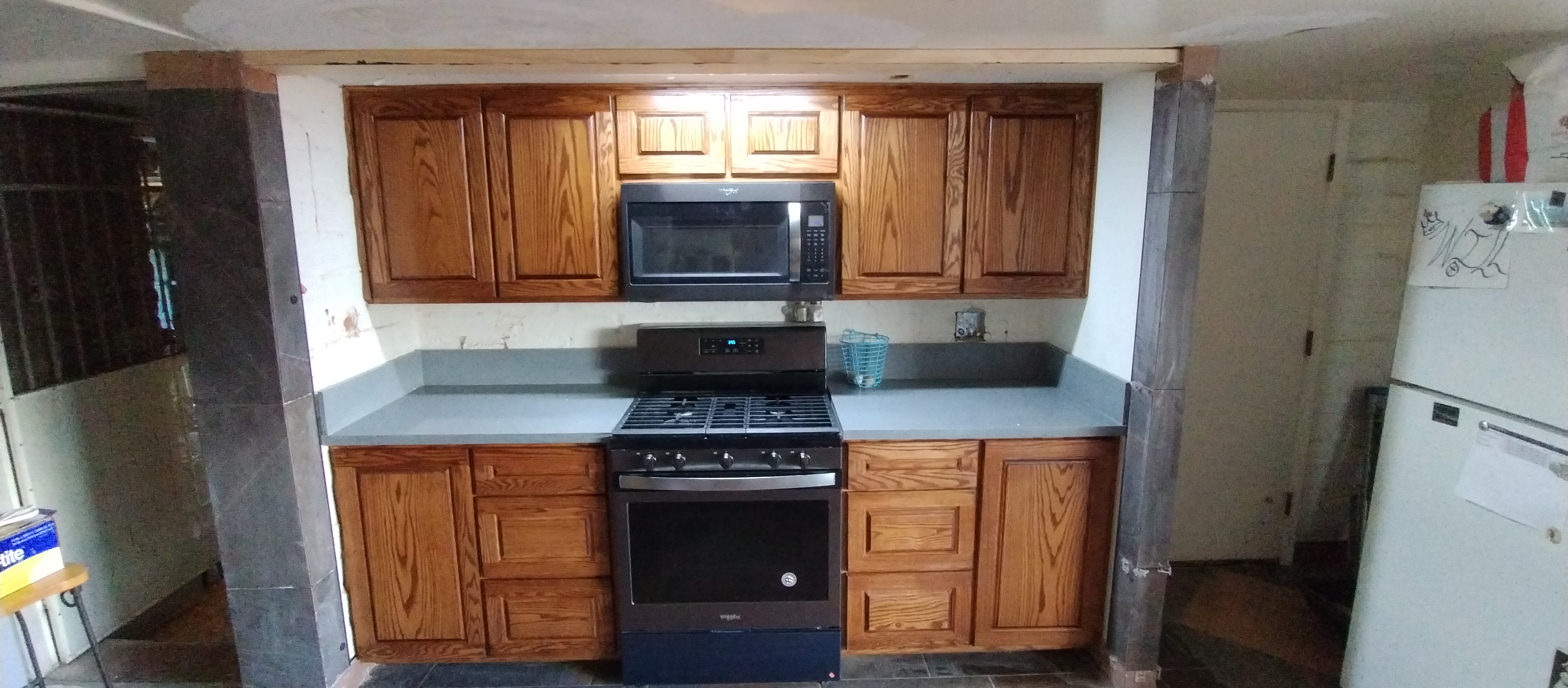 New Range, Microwave, Cabinets, and Countertops — Kitchen Nearly Complete