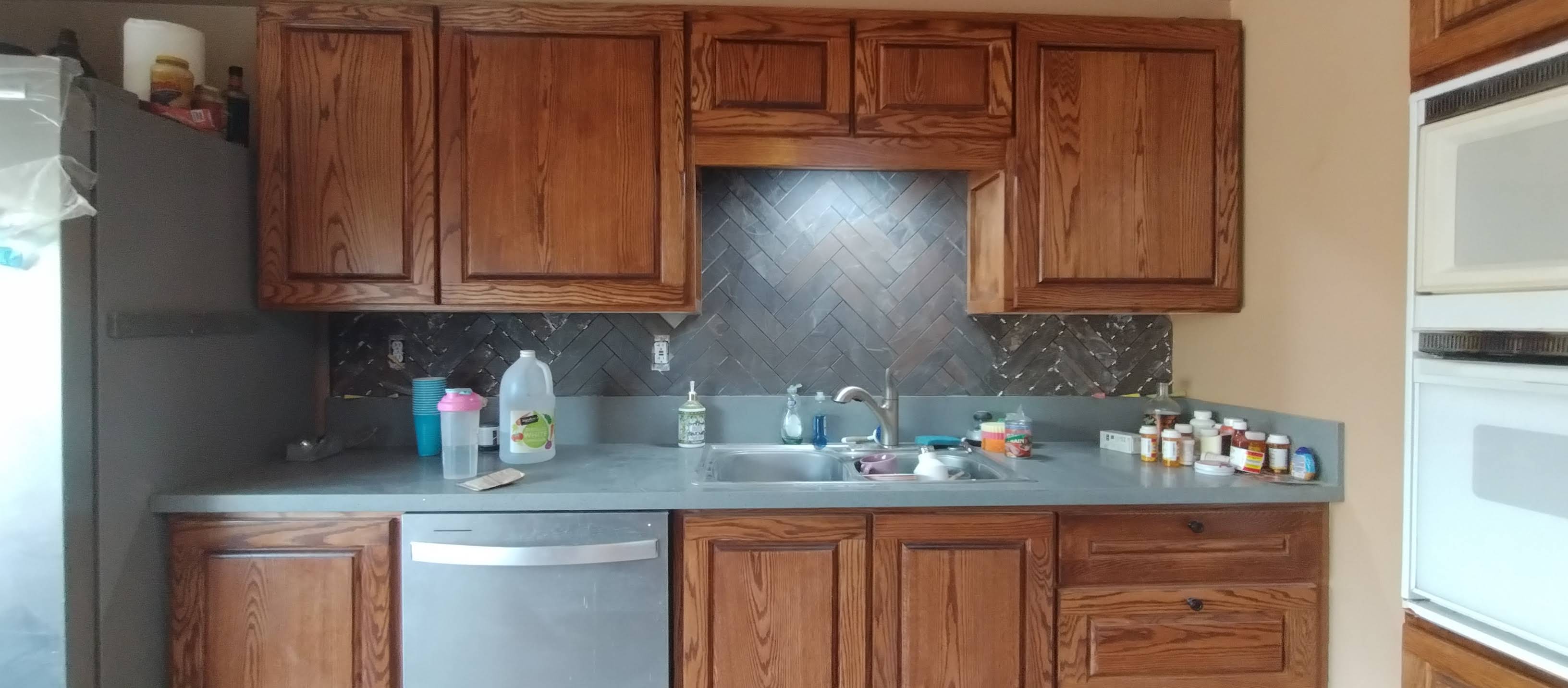 Upper & Lower Cabinets, Dishwasher, Sink, Countertop & Herringbone Backsplash